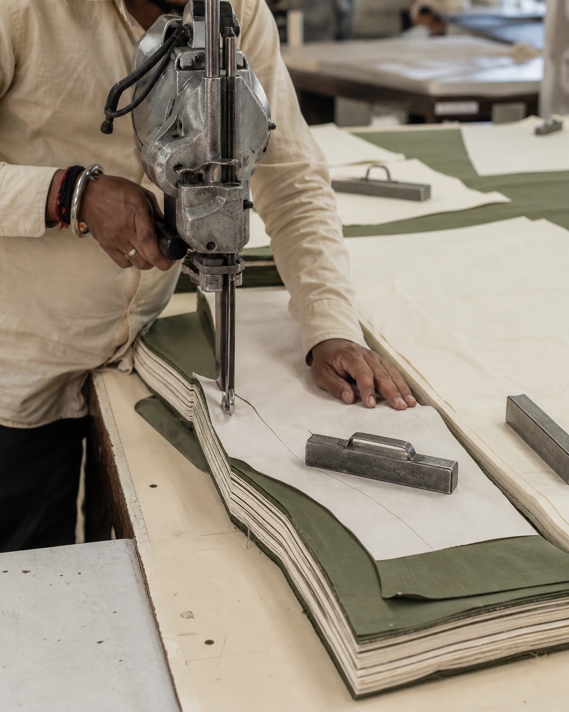 Skilled cutter cutting layered shirting fabric